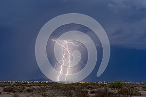 Two lightning bolts strike from a thunderstorm in Arizona