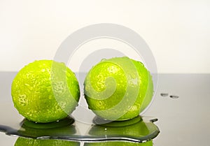 Two lime in water drops