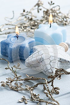 Two lit blue Christmas aroma candles