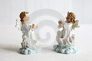 Two little angel stay on a white background