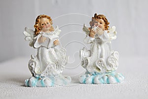 Two little angel stay on a white background