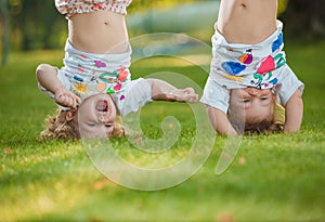 The two little baby girls hanging upside down