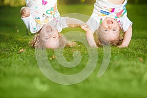 The two little baby girls hanging upside down