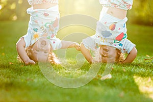 The two little baby girls hanging upside down