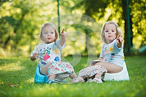 The two little baby girls hanging upside down