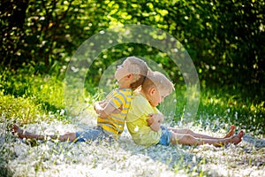 Two little boys , friends , resentful kids in summer day . Conc photo