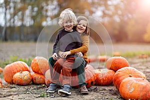 Two little boys having fun in a pumpkin patch