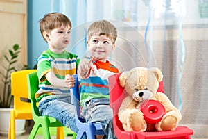 Two little boys playing role game in daycare