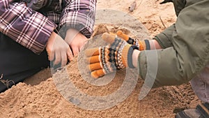 Two little boys playing with sand in sandbox