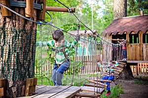 Two little boys playing together and having fun. Lifestyle family moment of siblings on playground. Kids friends play on tree