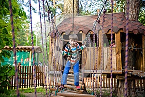 Two little boys playing together and having fun. Lifestyle family moment of siblings on playground. Kids friends play on tree