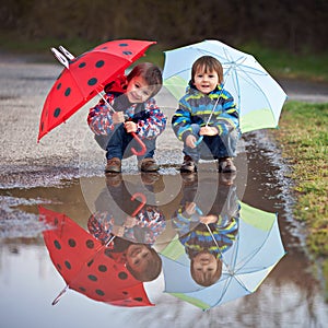 Two little boys with umbrellas