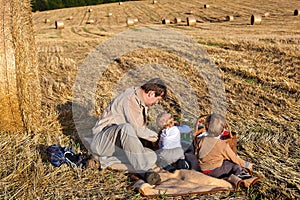 Two little boys and young father making evening picnic