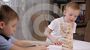 Two little brothers are playing an educational wooden blocks game.