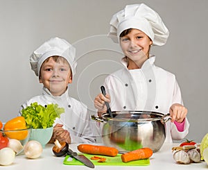 Two little chefs cook and smile