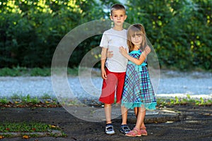 Two little children brother and sister together. Girl in dress h