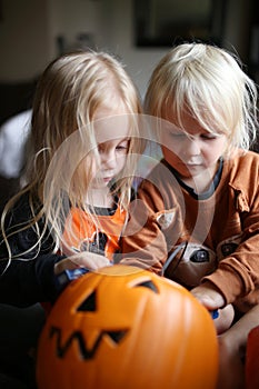 Two Little Girl Children Digging Through Halloween Pumpkin Bucket for Candy