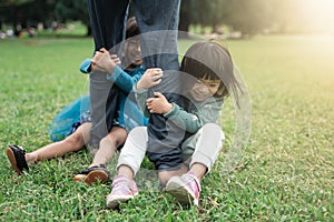 Two little girl holding foot her father