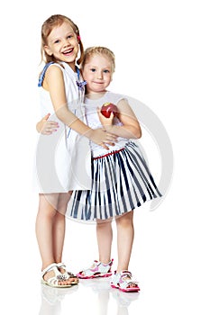 Two little girls with an apple