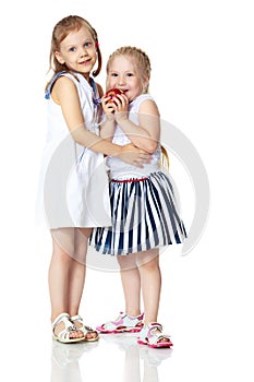 Two little girls with an apple