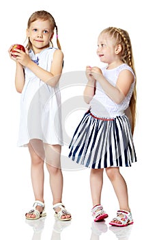 Two little girls with an apple