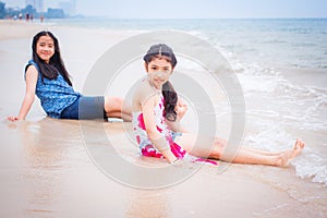 Two little girls are on the beach.