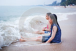 Two little girls are on the beach.