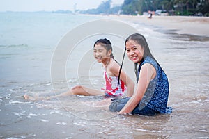 Two little girls are on the beach.