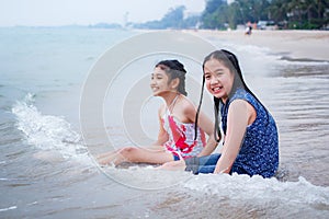 Two little girls are on the beach.