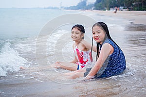 Two little girls are on the beach.