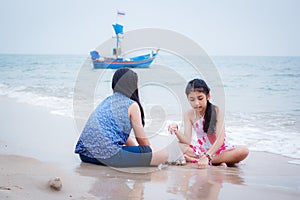 Two little girls are on the beach.