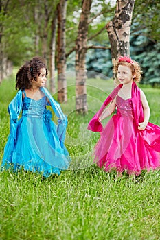 Two little girls in beautiful puffy gowns perform photo