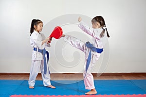 Two little girls demonstrate martial arts working together