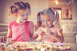 Two little girls have playing with Lego blocks.