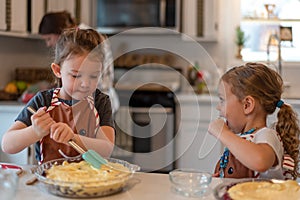 Two little girls helping make pies for the holidays