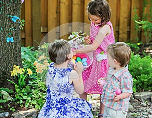 Two Little Girls Looking at Easter Eggs in a Basket