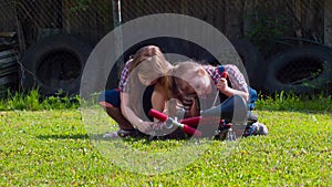 Two little girls mechanics are repairing a bicycle