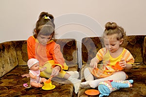 Two little girls play house