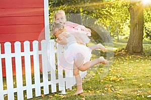 The two little girls at playground against park or green forest