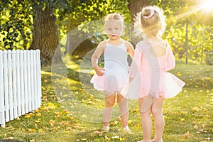 The two little girls at playground against park or green forest