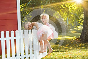 The two little girls at playground against park or green forest