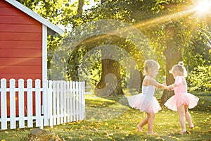 The two little girls at playground against park or green forest