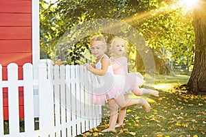 The two little girls at playground against park or green forest