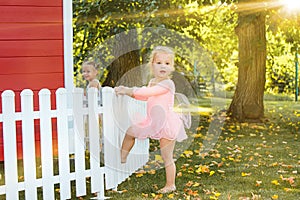 The two little girls at playground against park or green forest