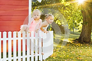 The two little girls at playground against park or green forest