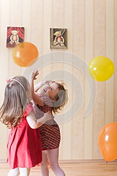 Two little girls playing with airy balls photo