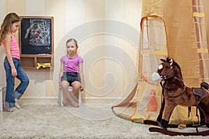 Two little girls playing in the gameroom photo
