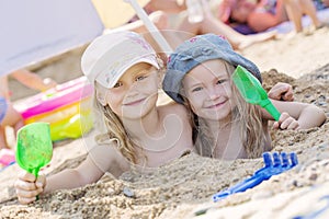 Two little girls playing in the sand