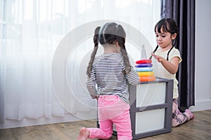 Two little girls playing small toy balls in home together. Education and Happiness lifestyle concept. Funny learning and Children