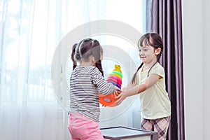 Two little girls playing small toy balls in home together. Education and Happiness lifestyle concept. Funny learning and Children